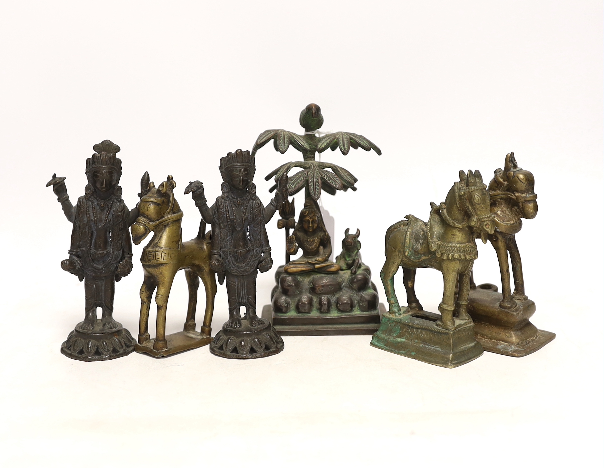 Six Indian bronze/brass ornaments; Shiva sitting under a bael tree with a bird, 17cm, two figures of Lord Vishnu and three horses